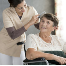 caregiver combing senior womans hair
